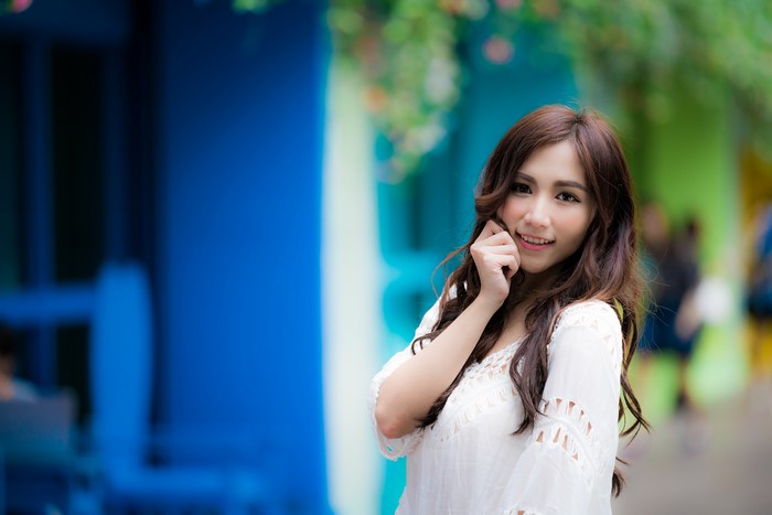 Asian woman with brown hair smiling