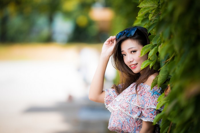 Asian woman with sunglasses and floral dress