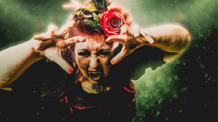 Woman with fangs and flowers in hair
