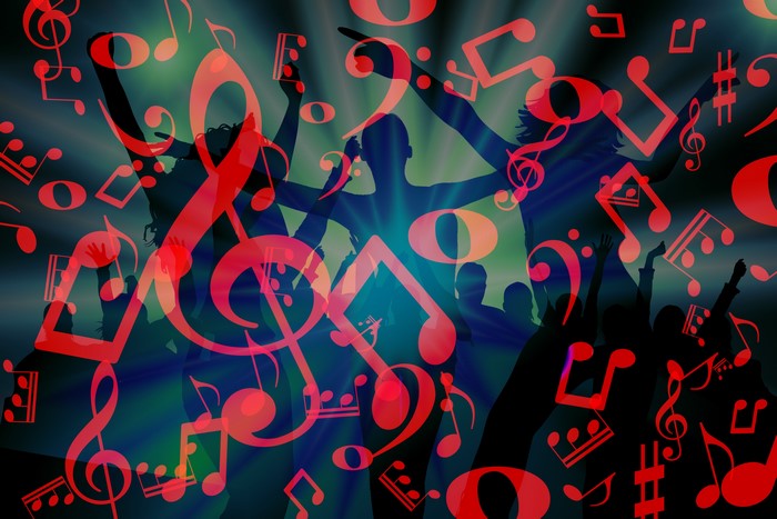 Silhouettes of people dancing with musical notes