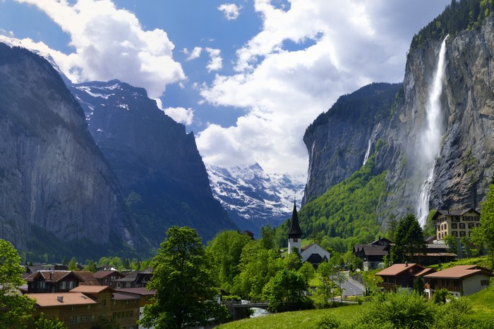 Lauterbrunnen village with Staubbach waterfall and Swiss Alps