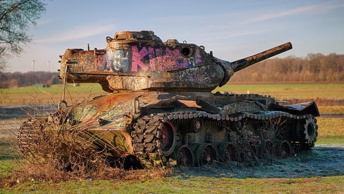 Graffiti-covered M47 Patton II tank in a field