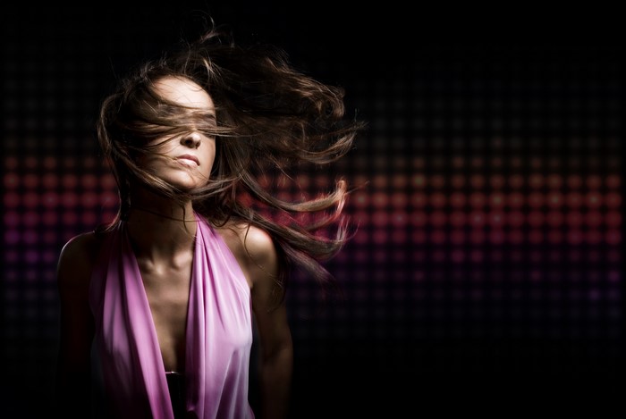 Woman with brown hair in a pink dress dancing