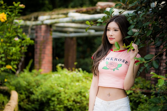 Asian woman in pink t-shirt and white shorts