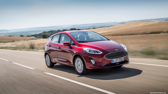 Red Ford Fiesta hatchback 2018 driving on a road