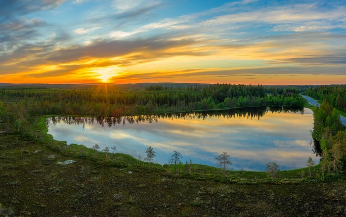 Sunset over a lake and forest in Kuusamo, Finland