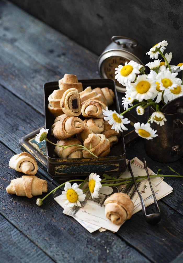 Croissants with camomiles on wooden planks