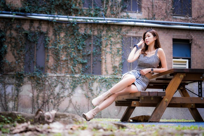 4K Asian Woman Sitting on Wooden Bench