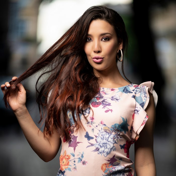 Woman with brown hair wearing a floral dress