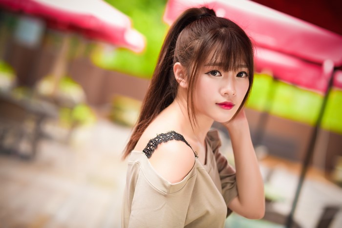 Asian woman with brown hair and bangs