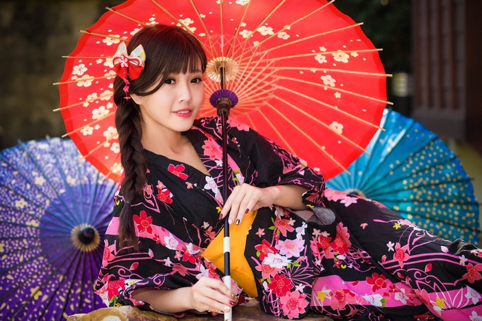 Asian woman in kimono with red umbrella