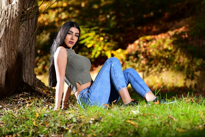 Anita, Brunette girl in jeans and singlet sitting on grass