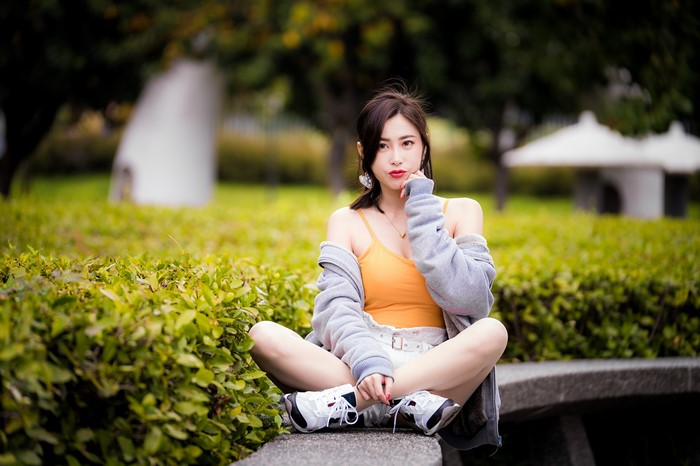 Asian woman sitting in a park