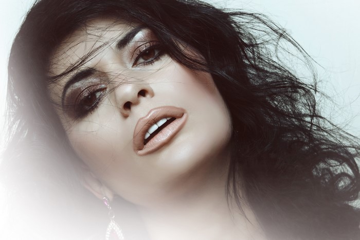 Brunette girl with makeup and flowing hair