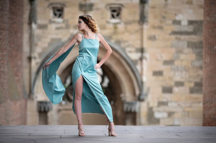 Morgane in a blue dress posing outdoors