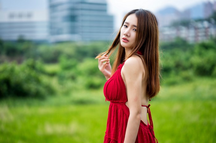 Asian woman in red dress with brown hair