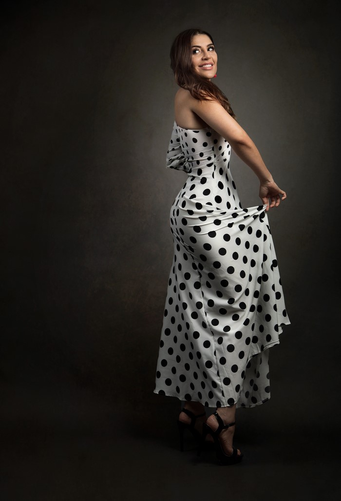 Priscila in a polka dot dress posing