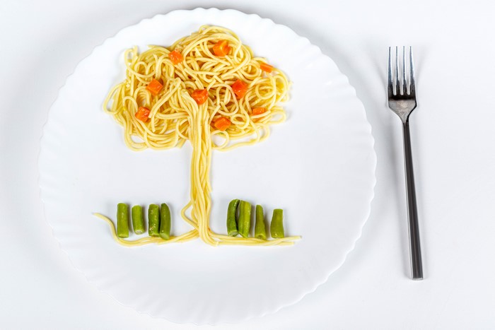 Spaghetti tree with carrots and green beans on a plate with a fork