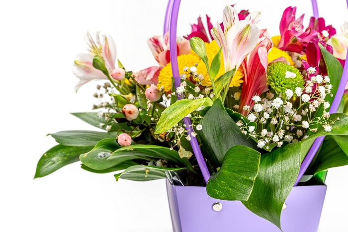 Bouquet of Alstroemeria flowers in a purple basket