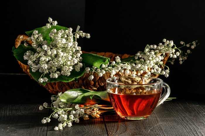 Tea and Lilies of the Valley in a Wicker Basket