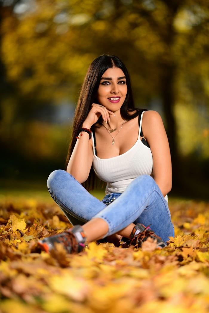 Anita sitting in autumn foliage