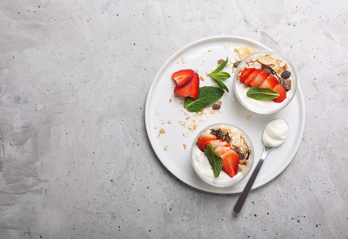 Yogurt with strawberries and muesli on a plate