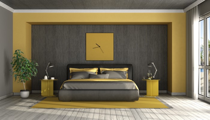 Bedroom with yellow and gray accents and a clock