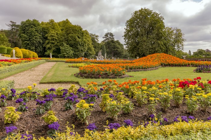 Waddesdon Manor gardens with flower beds and trees