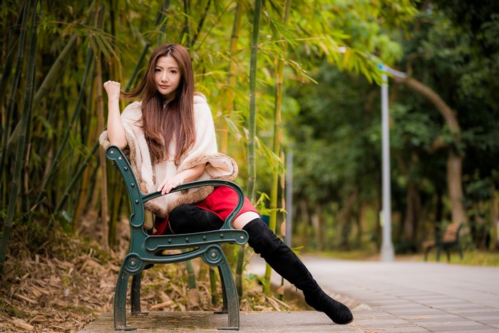 Asian Woman Sitting on Bench in 4K