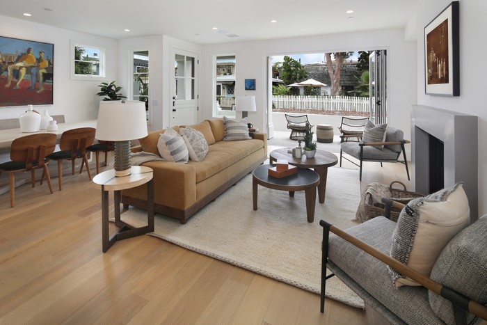 Living room with sofa, coffee tables, and fireplace