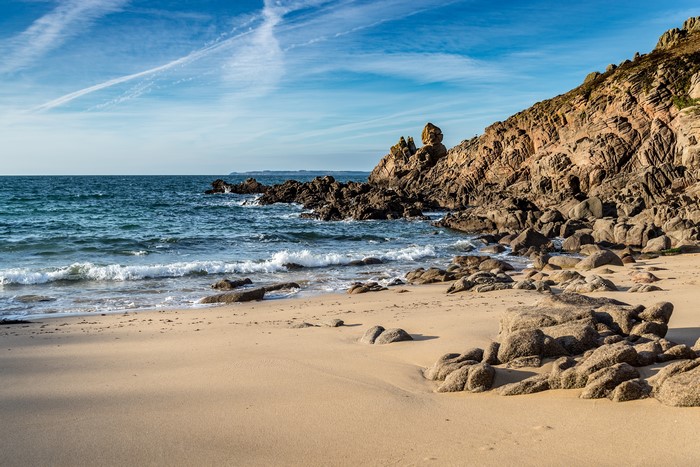 Rocky Coastline with Waves and Sandy Beach