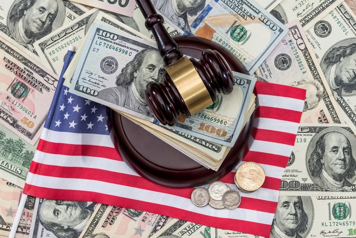 Gavel on American Flag and US Dollar Bills
