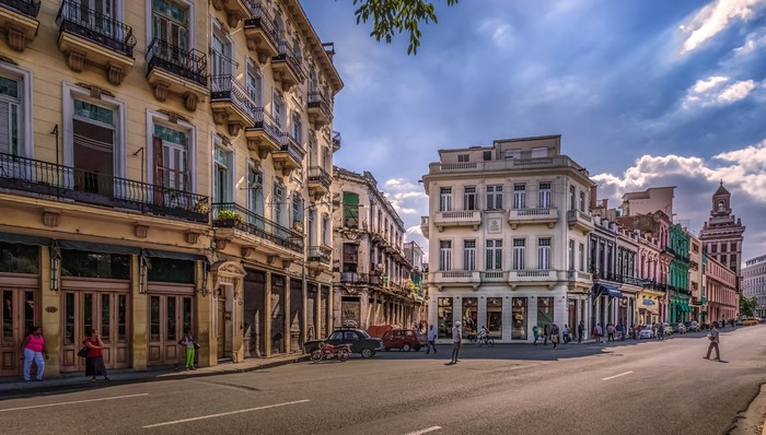 Street view of Havana, Cuba with colorful buildings and cars