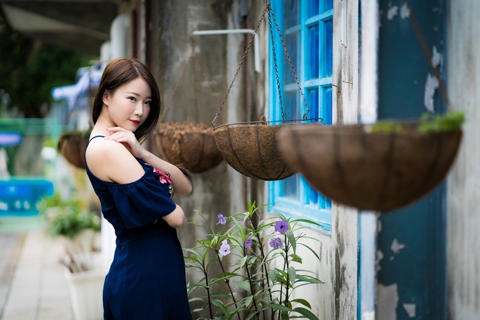 Asian woman in a blue dress posing outdoors