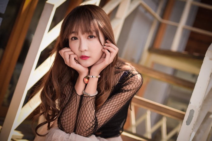 Asian woman with brown hair and bangs