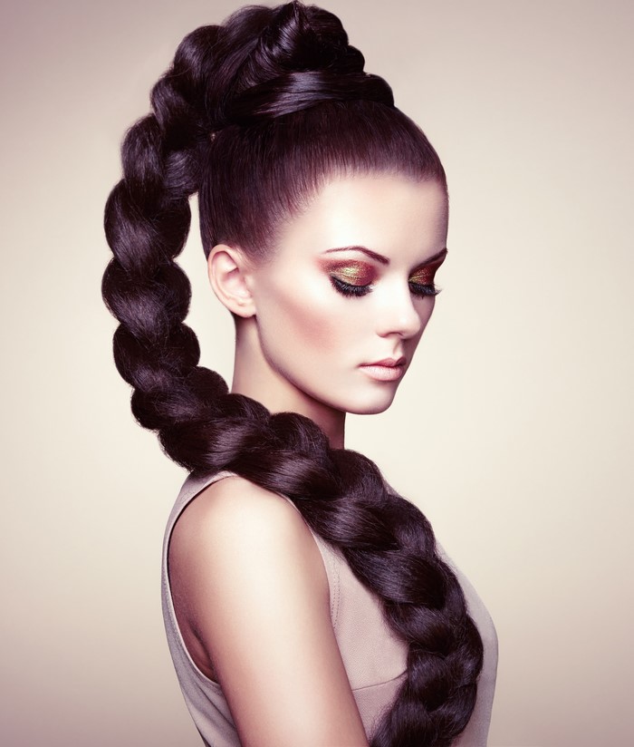 Brunette woman with elaborate braid and makeup