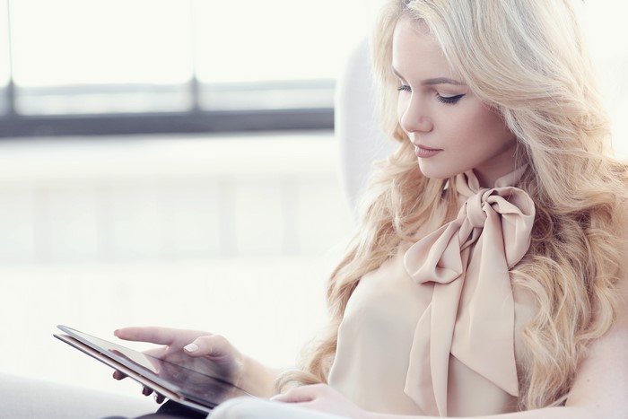Blonde woman with tablet computer