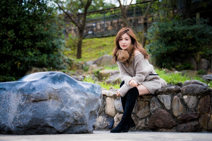 Asian woman sitting on stones