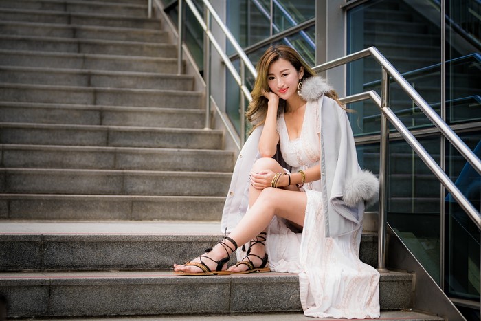 Asian woman sitting on stairs