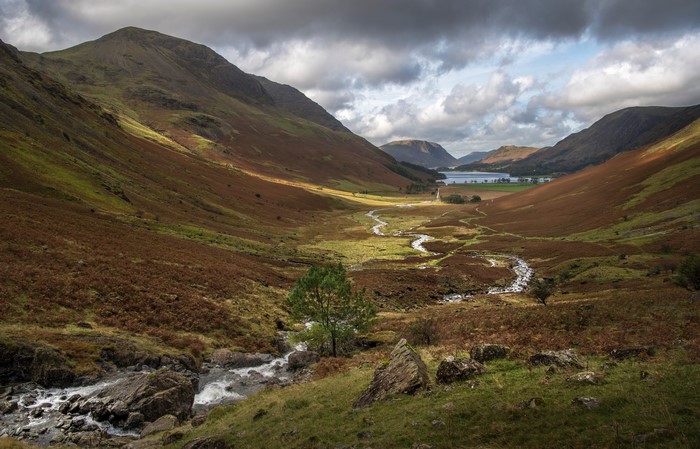 Valley with Stream, Mountains, and Lake in the Distance