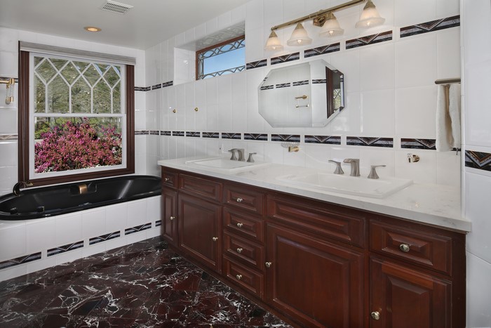 Bathroom with bathtub and double vanity