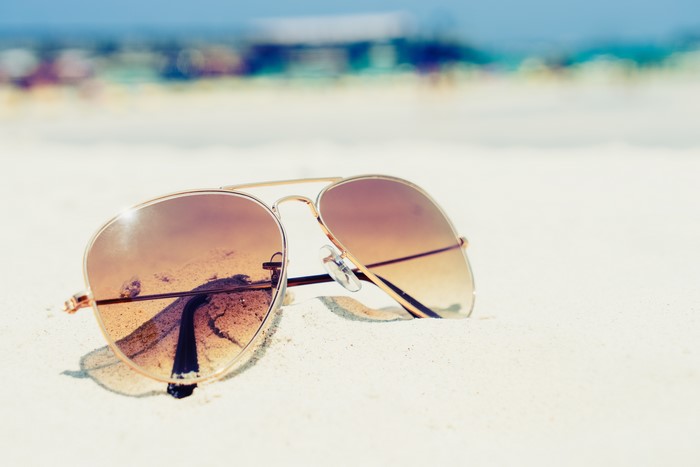 Aviator sunglasses on a sandy beach