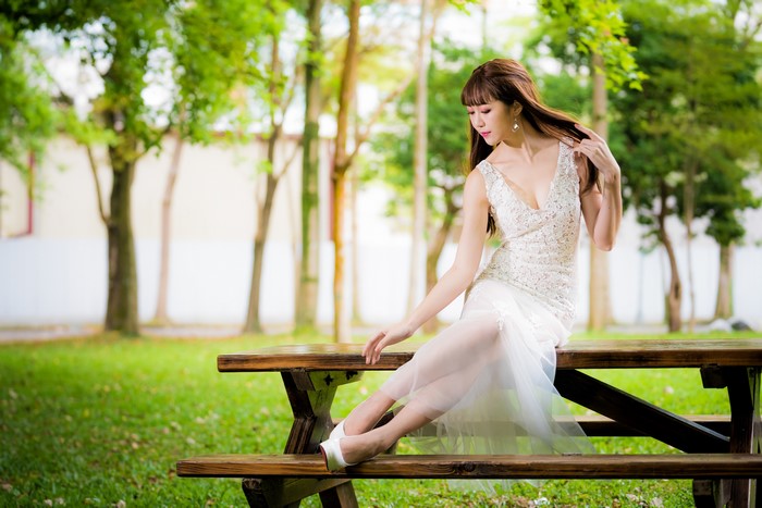 4K Asian Woman Sitting on Wooden Bench