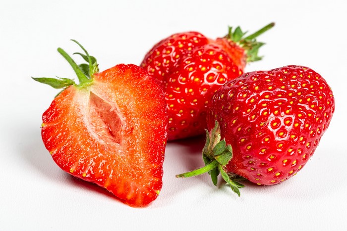Three Strawberries, One Cut in Half