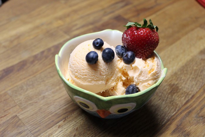 Ice cream with strawberry and blueberries in a bowl