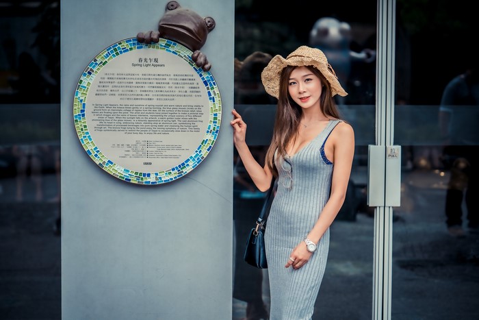 Asian woman in dress and hat
