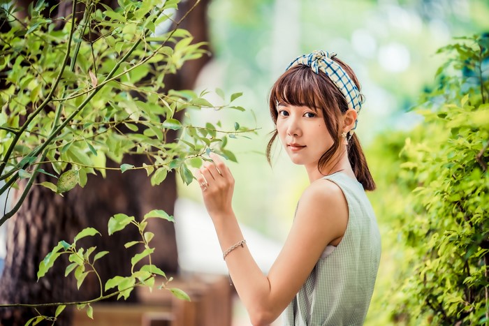 Asian woman with brown hair and headband