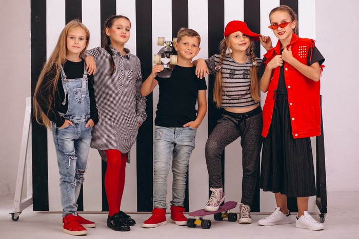 Children posing with a skateboard