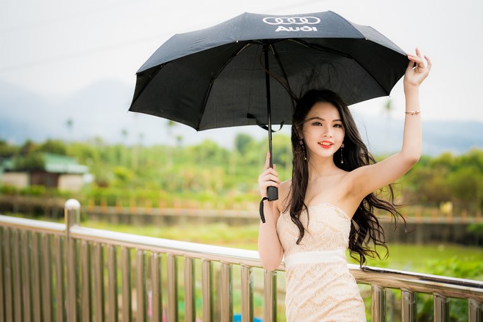 Brunette girl with Audi umbrella
