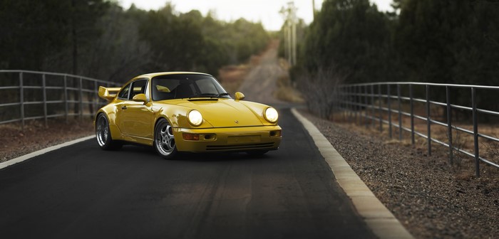 Yellow Porsche 911 Carrera RS 3.8 Coupe on Road